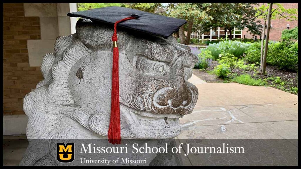 Journalism arch lion wearing mortar board and tassel.