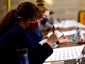 Senior Sara Dingmann takes handwritten notes May 5 in the media gallery of the Missouri House of Representatives.