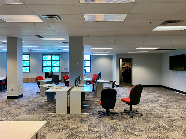 Furniture moves back into the School's shared newsroom even as renovation continues on the space. | Nate Brown