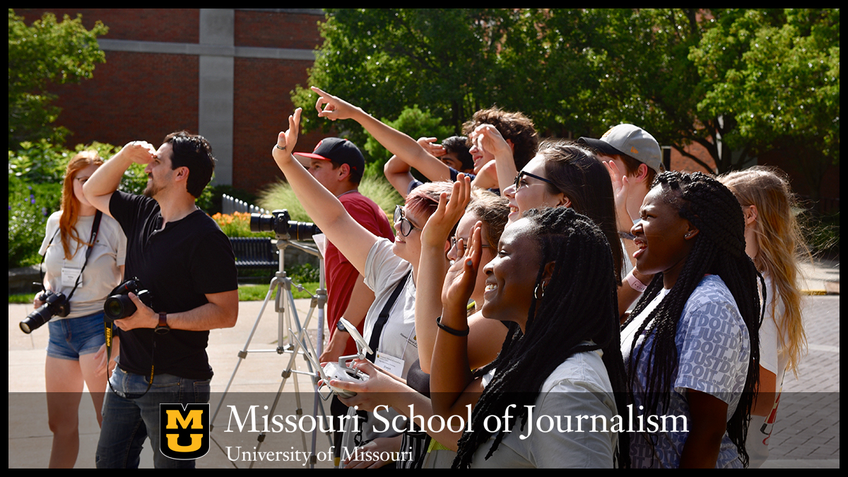 Missouri Advertising and Public Relations Workshop students smile and wave as graduate student Sarah Sabatke, center with controller, takes a selfie during a drone demo this afternoon on Francis Quadrangle. The high schoolers were learning creative uses for drones during day four of the workshop, led by Associate Professor Frank Corridori, left, in black shirt. Seventy-nine students from 11 states are here participating in three concurrent workshops: the PR workshop, the Missouri Investigative Journalism Workshop and MUJW: Missouri University Journalism Workshop. The students in the PR workshop are developing a strategic communication campaign for Harold's Doughnuts. #MissouriMethod #MizzouMade #MUJSchoolWorkshop2019 Photo by Nate Brown | copyright: 2019 - Curators of the University of Missouri