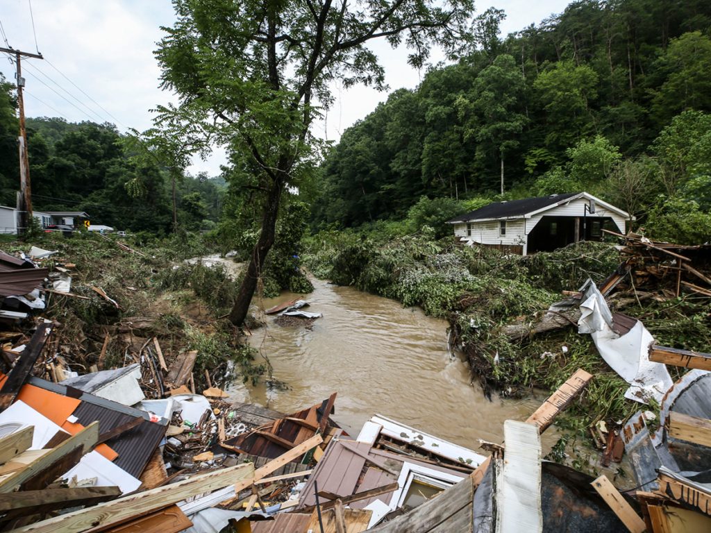 Debris from destroyed homes piles up near a concrete bridge over Grapevine Creek in Perry County after torrential rain caused flash flooding in Eastern Kentucky on July 28, 2022. Credit: Matt Stone, The Courier-Journal