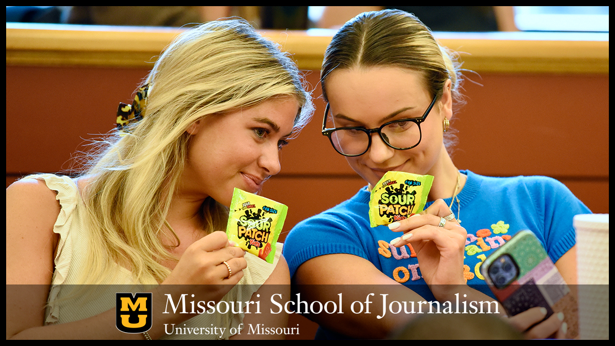 Seniors Kate Cupp and Kallie Lehenbauer of MoJo Ad take a selfie with their new client's product Aug. 22, 2022, in Lee Hills Hall. Sour Patch Kids was announced as this semester's client on the first day of class.