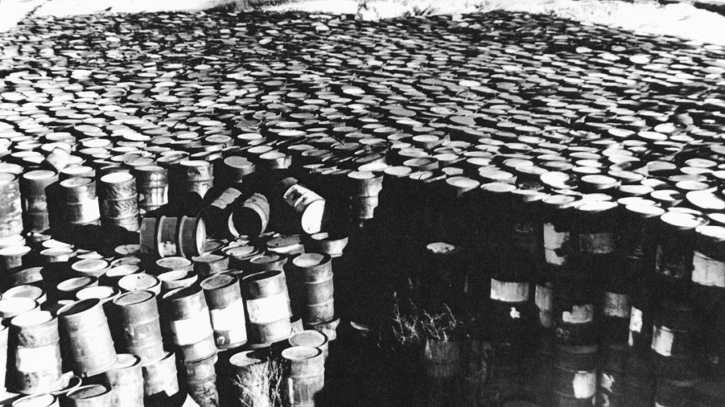 A photo taken in 1960 of deteriorating steel drums containing radioactive residues near Coldwater Creek, by the Mallinckrodt-St. Louis Sites Task Force Working Group | State Historical Society of Missouri, Kay Drey Mallinckrodt Collection, 1943-2006