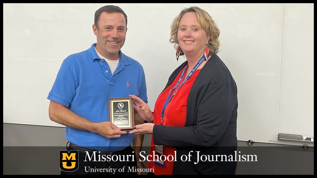 Jon Stemmle receives his award from April Fiesler Avery, president of MEMO