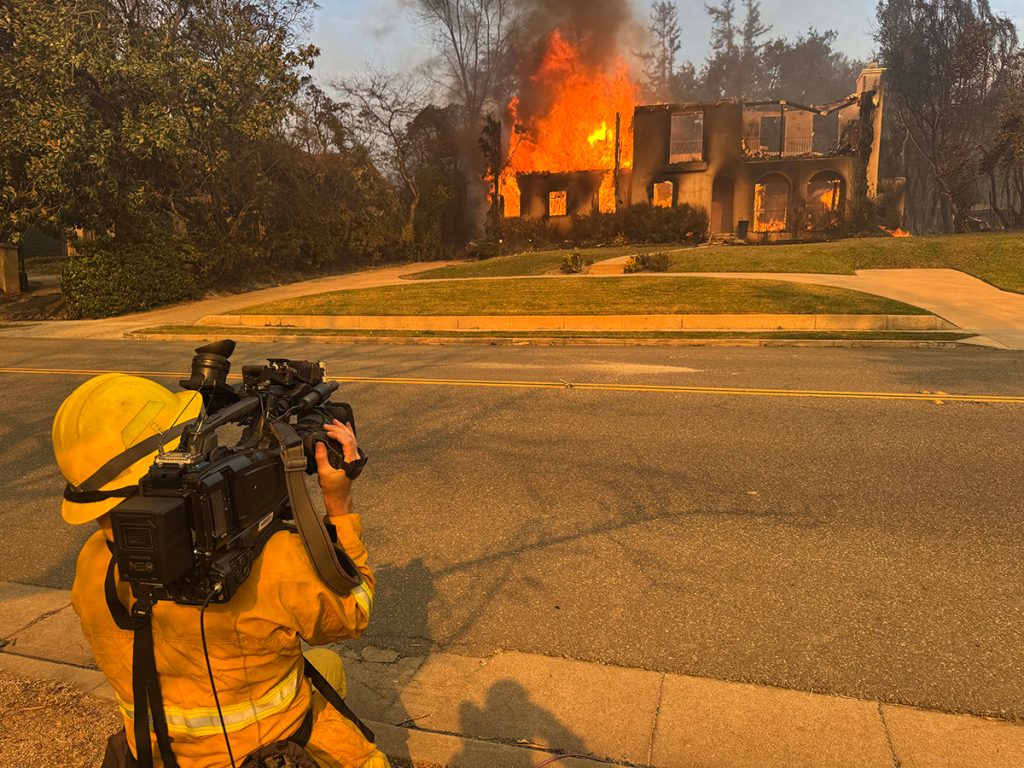 John Schreiber covers the Eaton Fire in Altadena on January 8, 2025. Shortly after, he helped save chickens from the house next door as the fire spread.