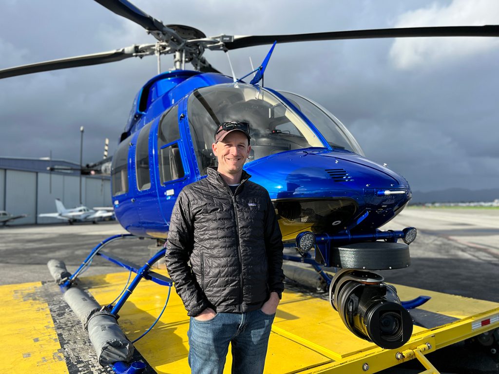 John Schreiber with one of three Bell 407 news helicopters he flies in for CBS Los Angeles. The camera's zoom is capable of reading a license plate on a vehicle from 2,000 feet in the air.