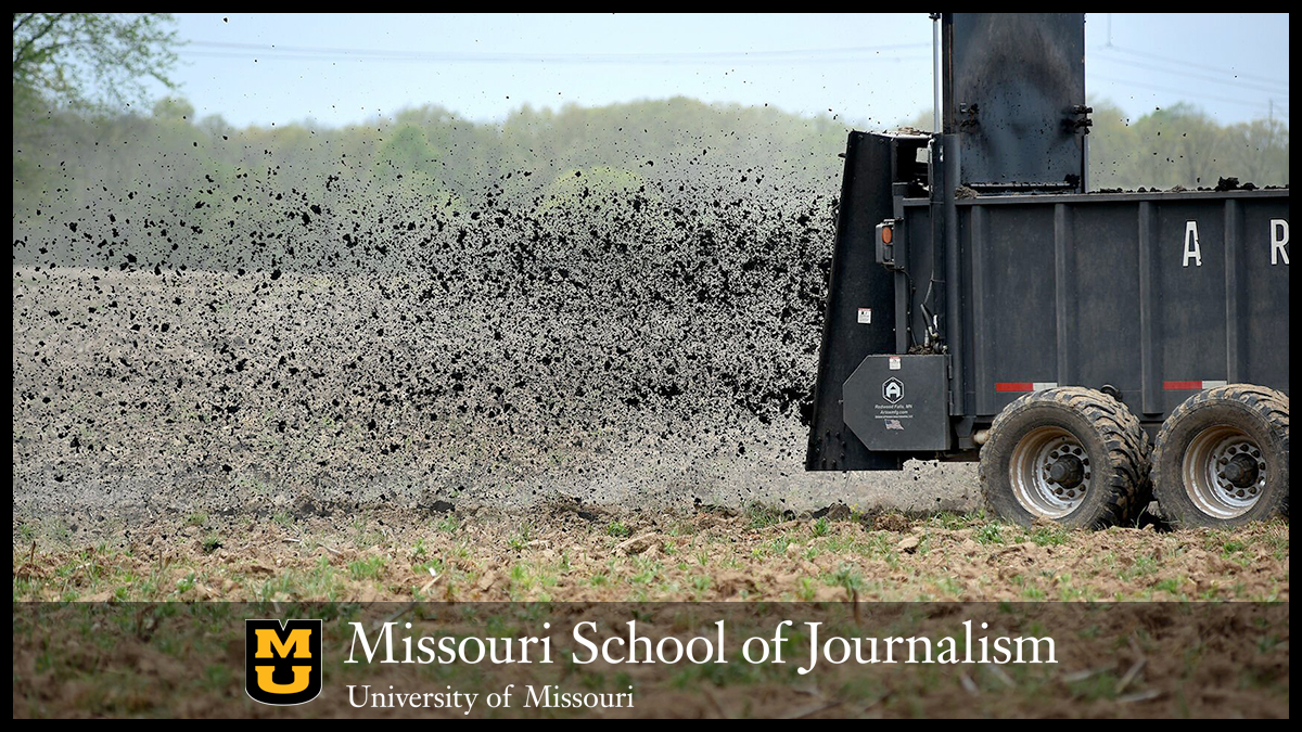 Vehicle spreading waste over farm field