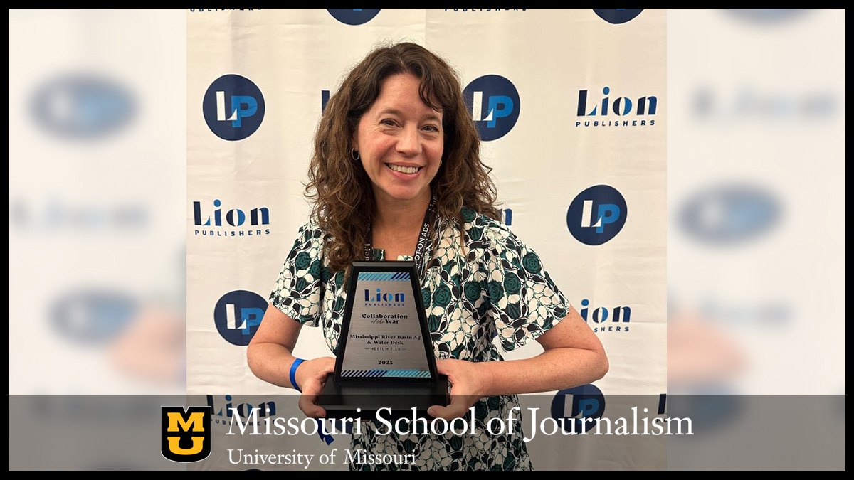 Sara Shipley Hiles holds the Collaboration of the Year Award in front of Lion Publishers background.