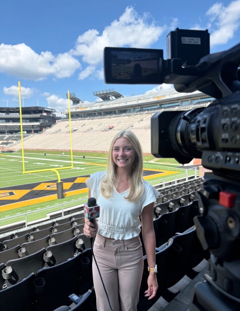 Bella poses for a standup for a story on NCAA transfer rulings at Mizzou Football's Fall Media Day.