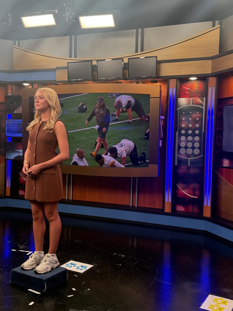 Morgan stands in the studio before the start of her 10 p.m. sports block.