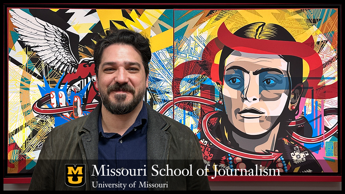 Frank Corridori stands in front of Muralistic Princess, which hangs outside his office in the strategic communication suite. The artwork is one of 15 prints hanging throughout the suite.