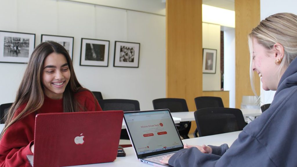 Journalism students Ayesha Khan (left) and Josie Menley create content for Mission-Driven Tech, a health care technology company founded by Eve McDavid, BJ ’08.