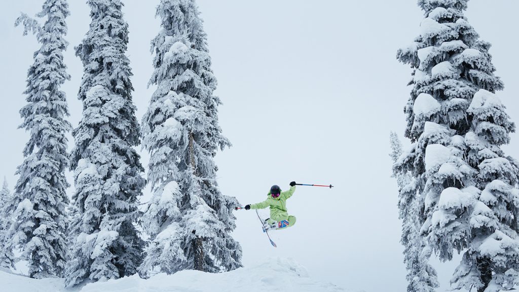 Erin Spong catches air while skiing down a snow-covered mountain