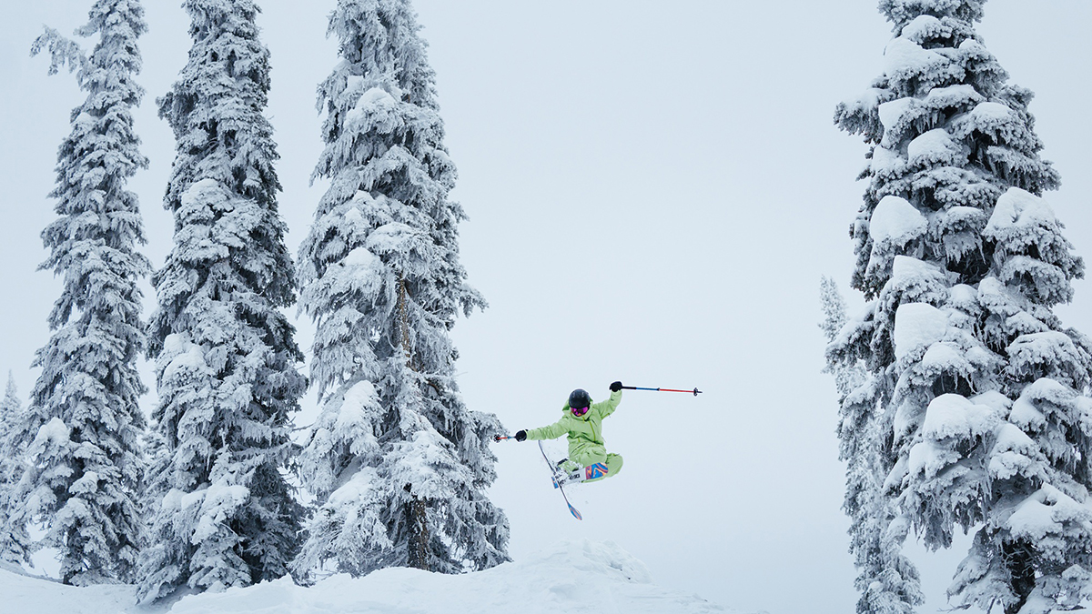 Erin Spong catches air while skiing down a snow-covered mountain