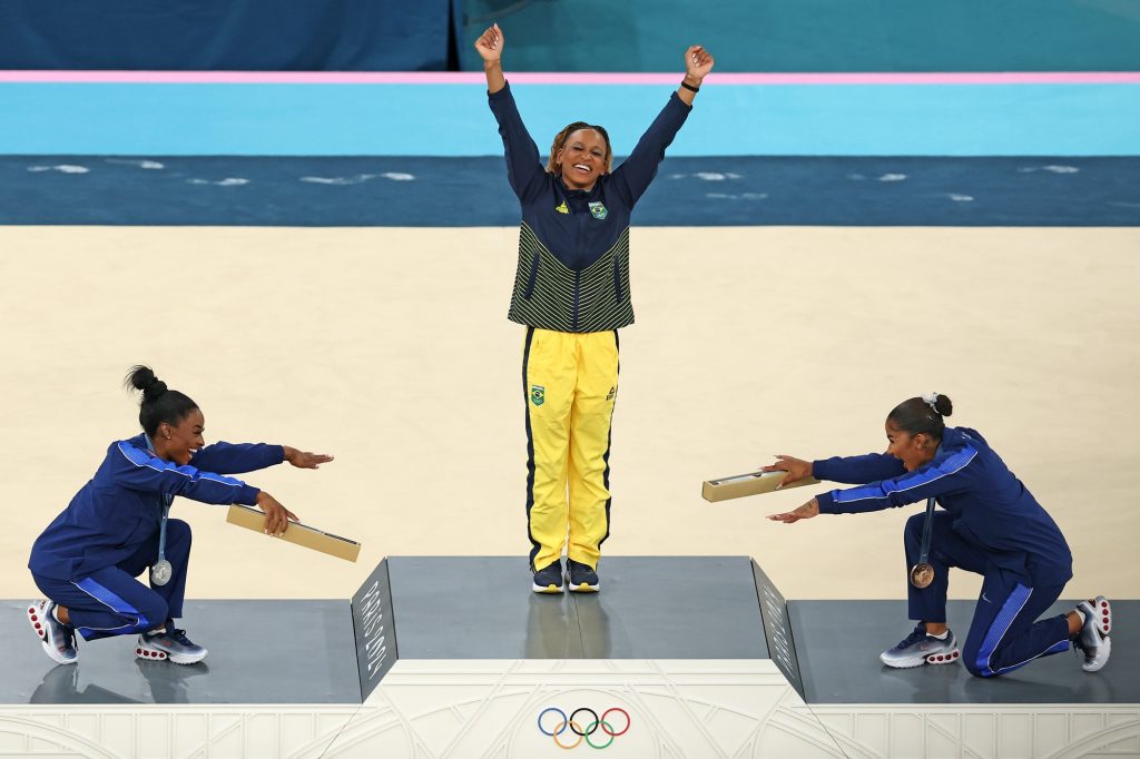 The first all-Black podium in Olympic gymnastics history, featuring Rebeca Andrade [Gold], Simone Biles [Silver], and Jordan Chiles [Bronze]. 
