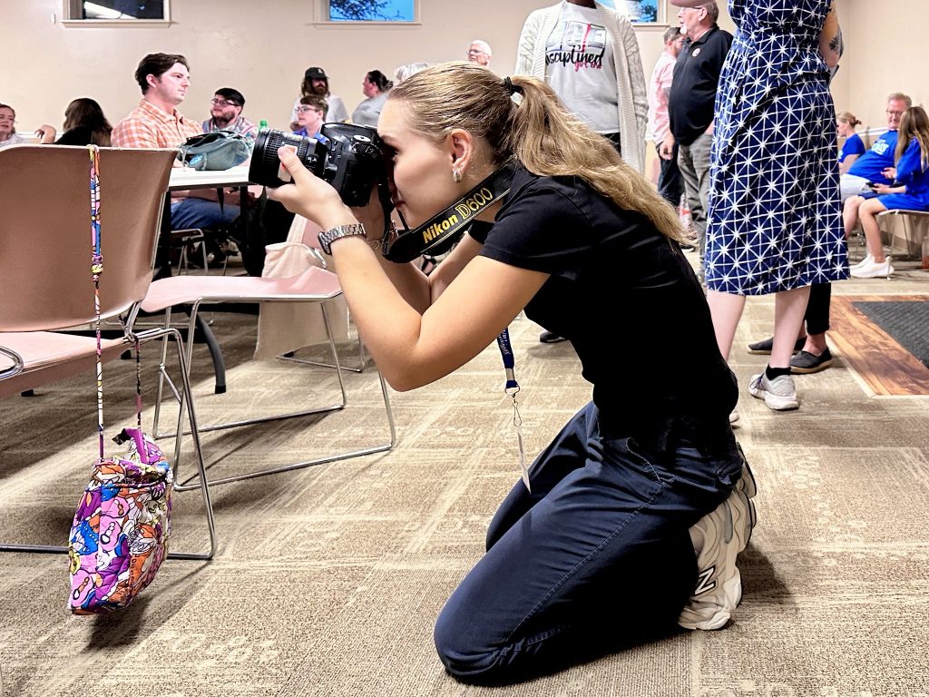 Columbia Missourian photographer Emily Early drops to the floor to photograph supporters at Sharon Jones’ watch party.